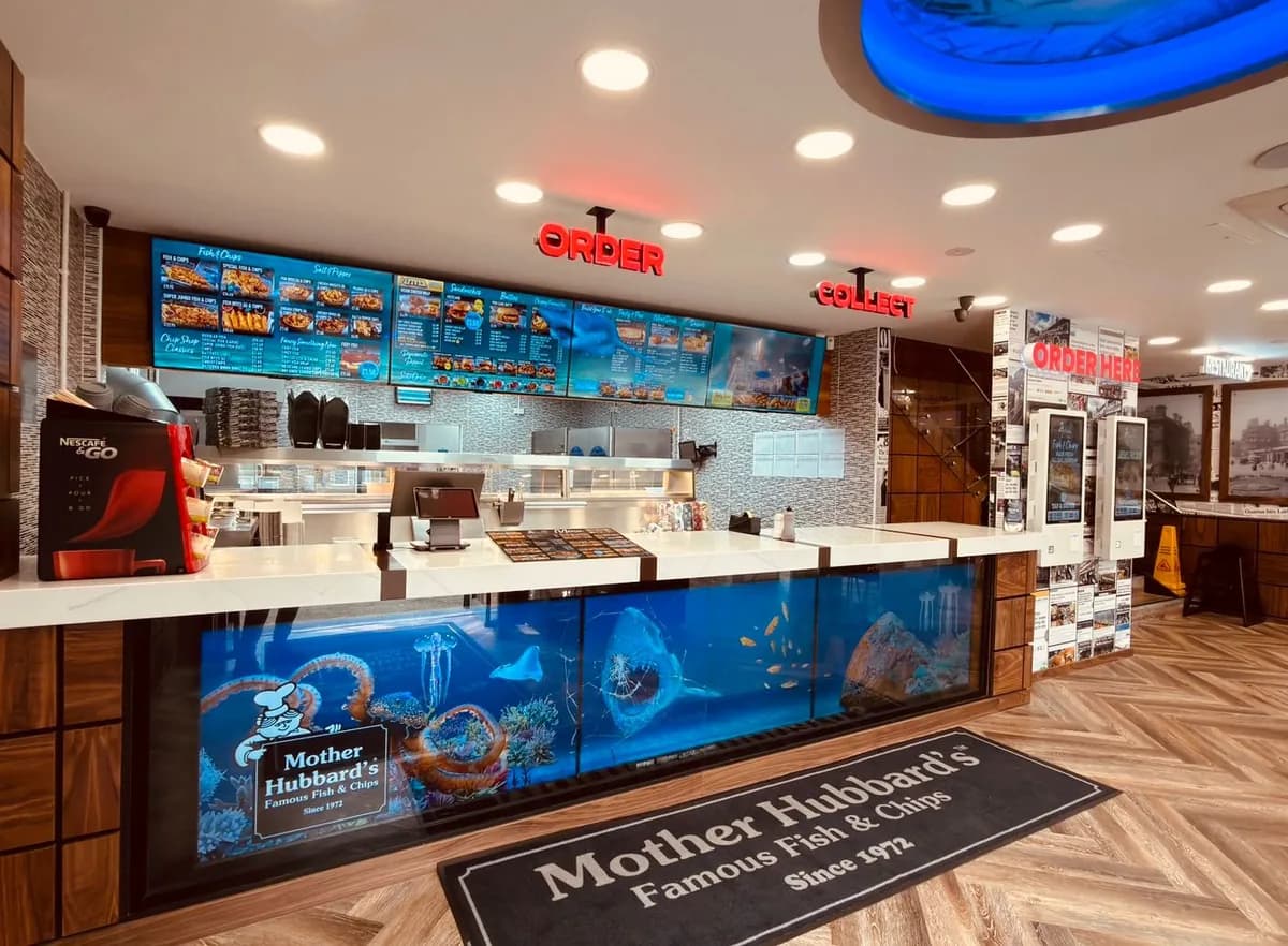 The counter, with the menu screens above and an aquarium under the glass