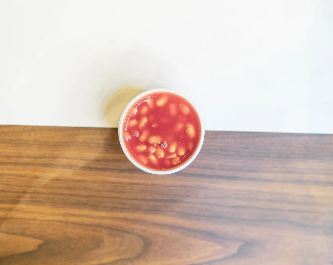 A pot of baked beans on a wooden table