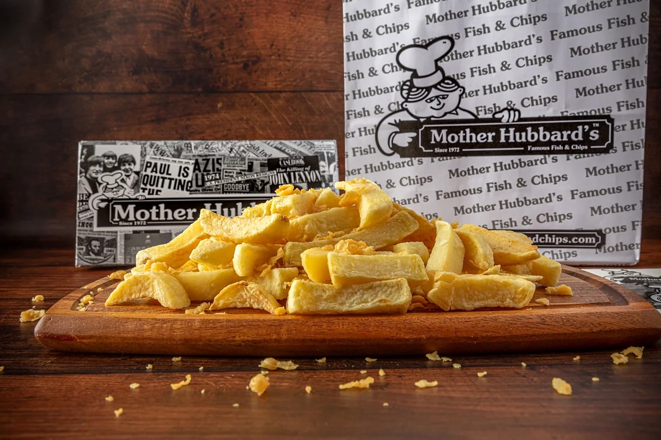 A close view of thick-cut chips on a wooden board
