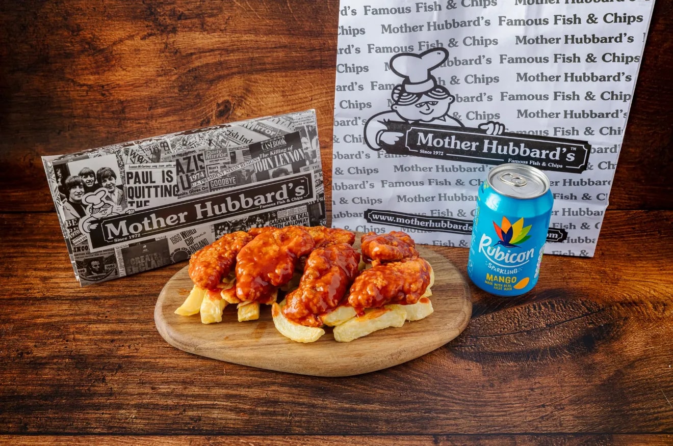 Dynamite-coated chicken strips on chips, with a can of Rubicon