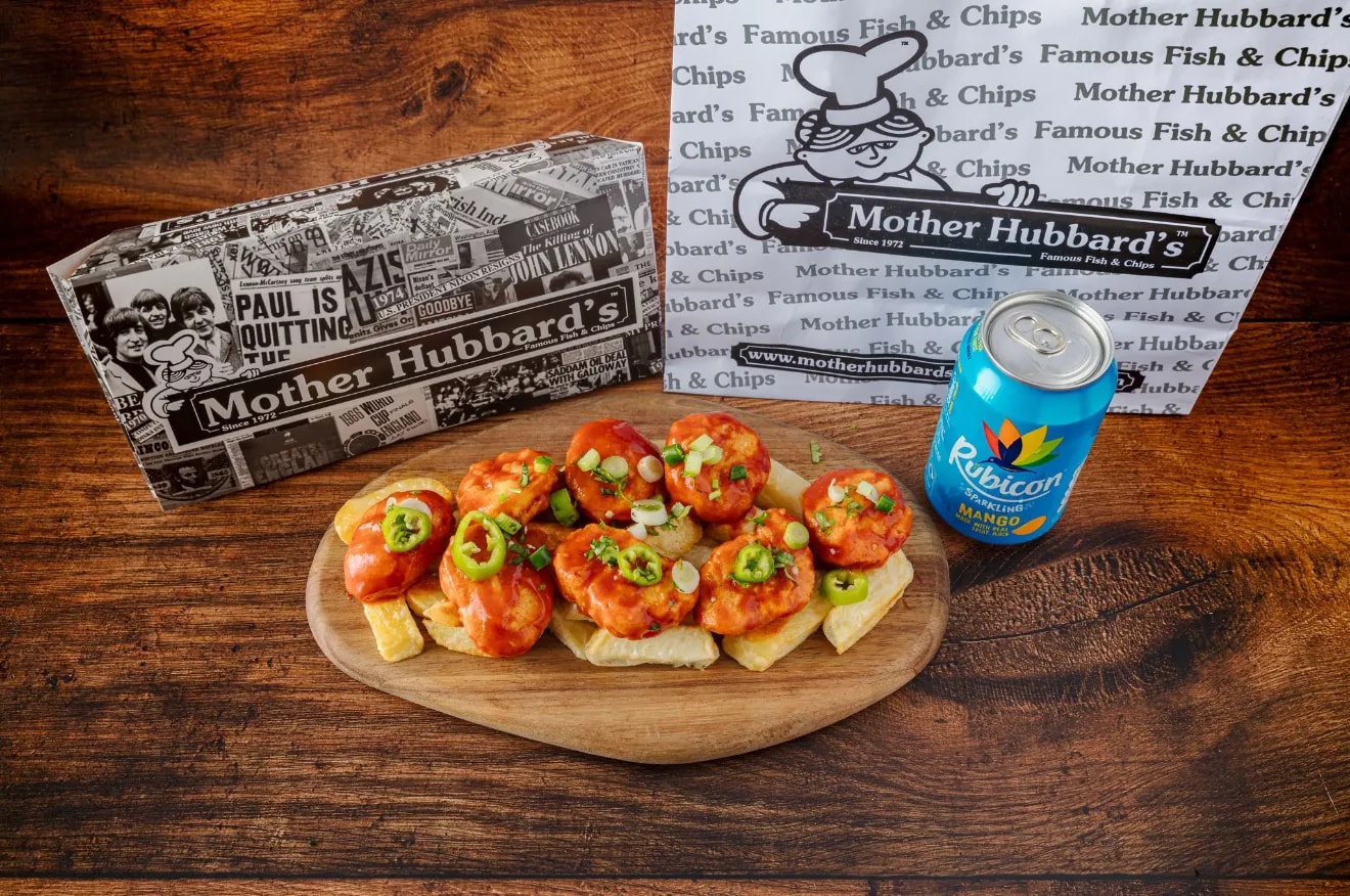 Dynamite nuggets topped with jalapeños on chips, with a can of Rubicon