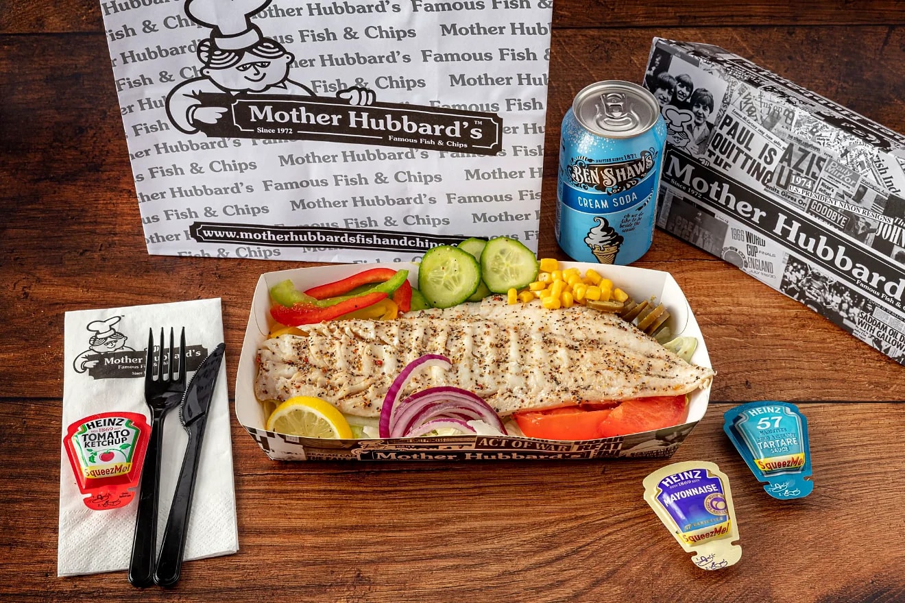 Grilled fish with salad, cucumber and red onion