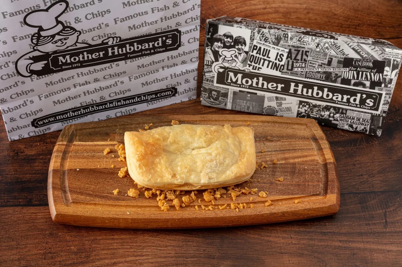 A golden keema pasty on a wooden board