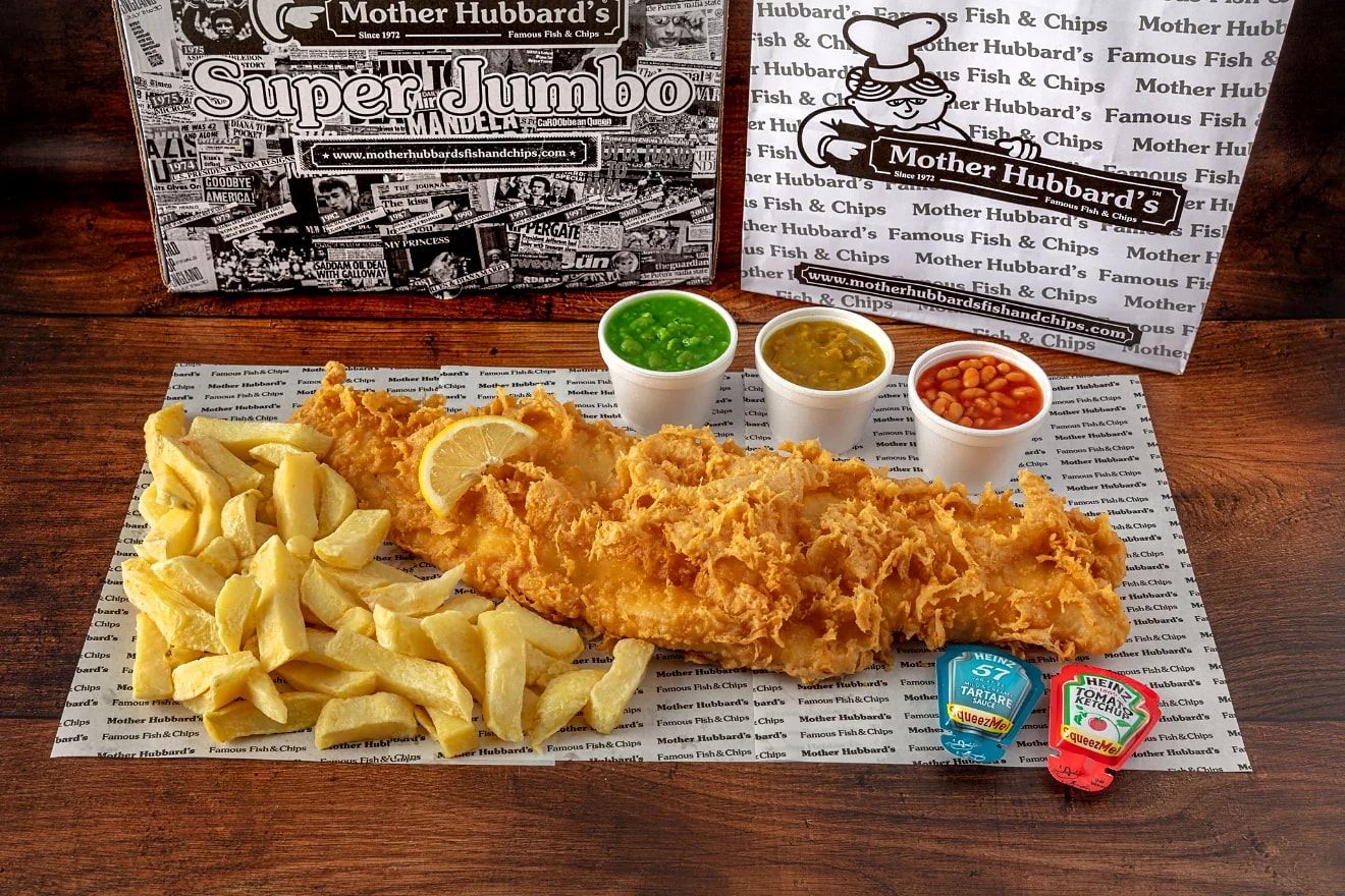 Super jumbo battered fish laid across a bed of chips